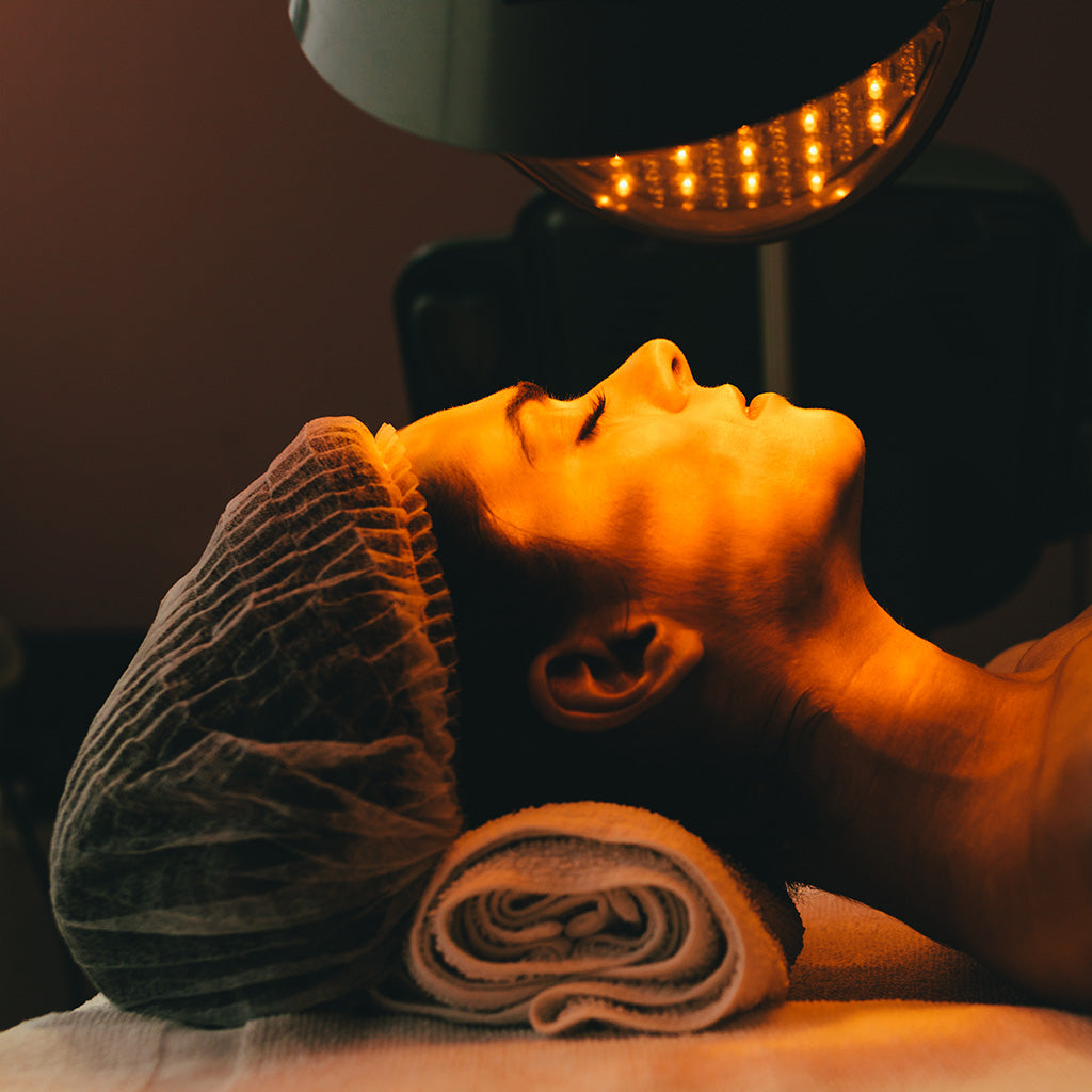 A woman receiving a Healite II LED Facial which is a part of our Laser & Light collection of treatments that promotes rejuvenation of the skin and reduces acne and breakouts.
