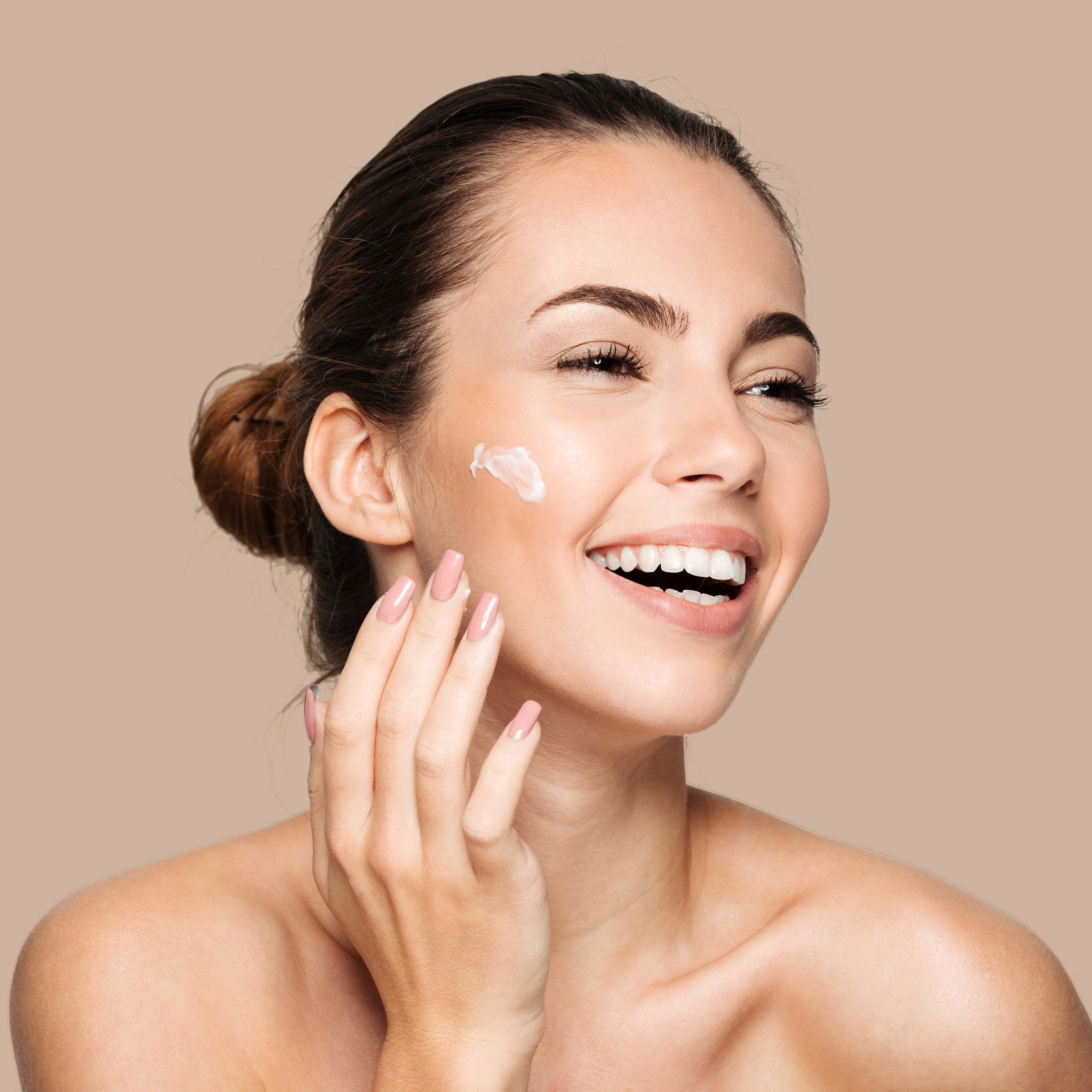 woman applying skincare to face.